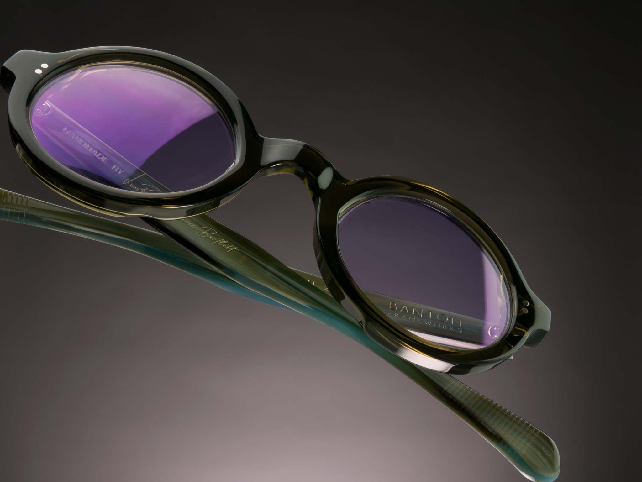 Close view of thick round green eyeglasses frame